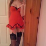 Teen girl in red lingerie strips.