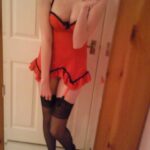 Teen girl in red lingerie strips.